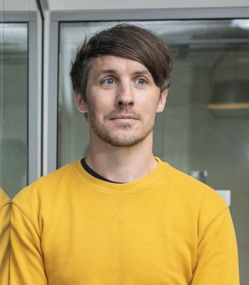 Artist Leon Butler in a yellow jumper portrait